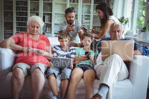 Multi-generation family using laptop, mobile phone and digital tablet