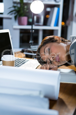 Businesswoman sleeping while working in office