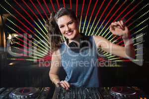 Pretty female DJ playing music