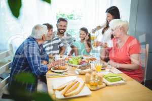 Multi-generation family sitting at breakfast table