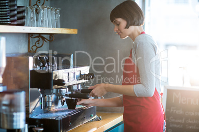 Waitress making cup of coffee