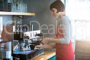 Waitress making cup of coffee