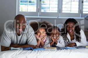 Happy family lying on bed