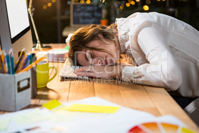 Tired businesswoman sleeping on the desk