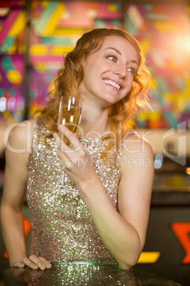 Young woman holding a glass of champagne