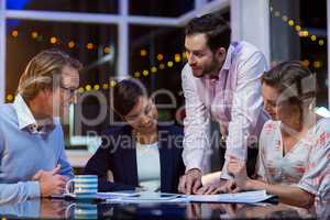 Businesspeople discussing on documents in office