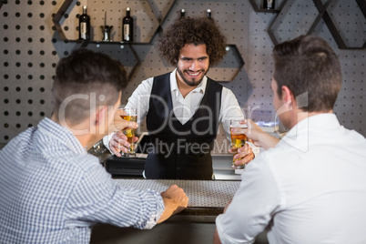 Bartender serving beer to customers