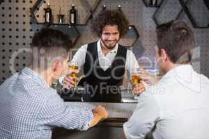 Bartender serving beer to customers