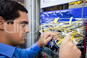 Technician checking cables in a rack mounted server