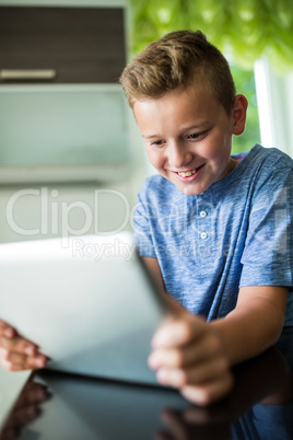 Boy using digital tablet at home