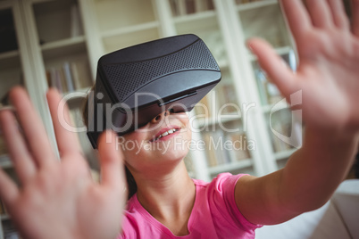 Girl looking through virtual reality headset in living room