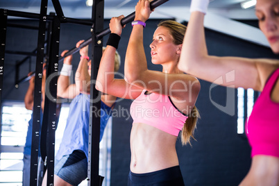 People doing chin-ups exercise in gym