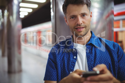 Portrait of handsome man using mobile phone