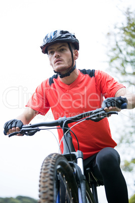 Male cyclist cycling in countryside