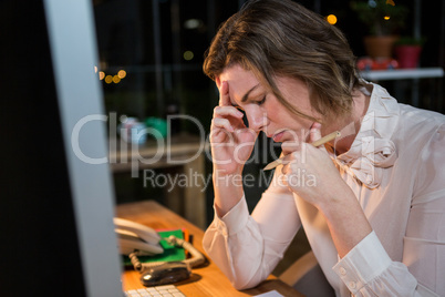 Stressed businesswoman sitting at her desk