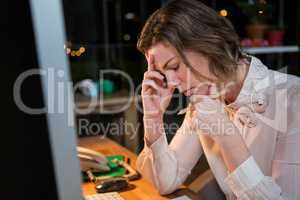 Stressed businesswoman sitting at her desk