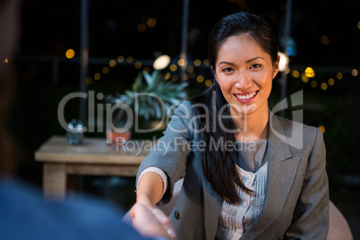 Businesswoman shaking hands with colleague