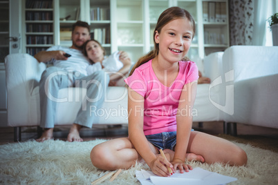 Girl sitting on the floor and drawing
