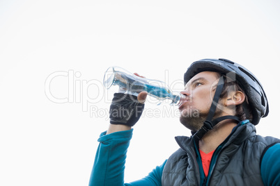 Male mountain biker drinking water