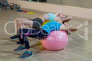 Two women exercising on exercise ball