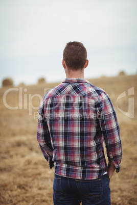 Rear view of farmer standing in the field