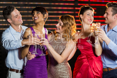 Group of friends toasting glasses of champagne