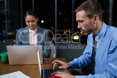 Businessman and businesswoman working in office