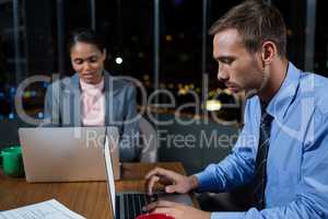 Businessman and businesswoman working in office