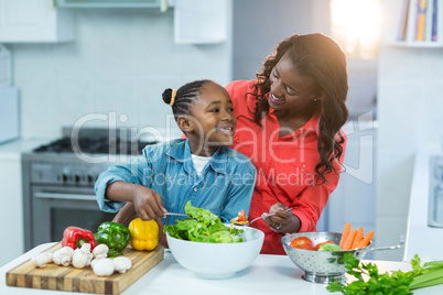 Mother and daughter preparing food