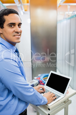 Portrait of technician working on laptop