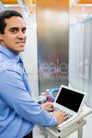Portrait of technician working on laptop
