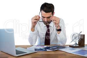 Businessman wearing spectacle while working in office