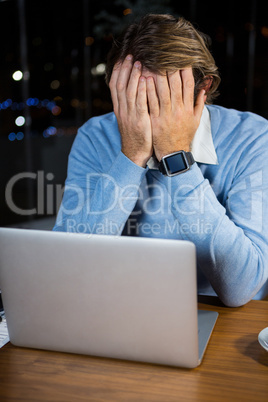 Stressed businessman sitting at his desk