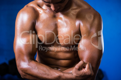 Muscular shirtless man in gym