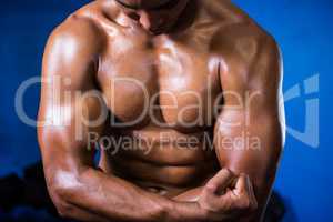 Muscular shirtless man in gym