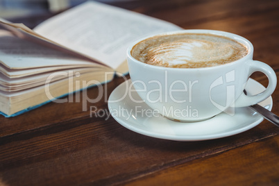 Cappuccino and book on table