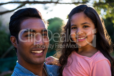 Father carrying daughter in his arms