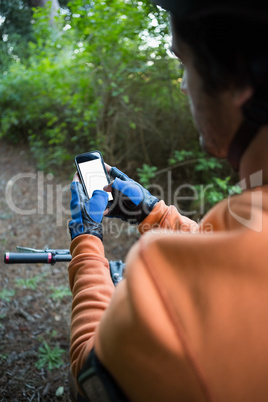 Mountain biker using mobile phone