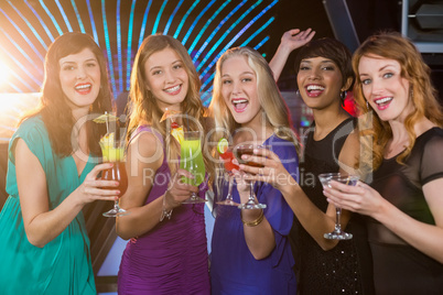 Group of friends having glass of cocktail at bar counter