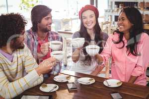 Group of happy friends holding cup of coffee