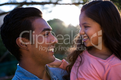 Father carrying daughter in his arms