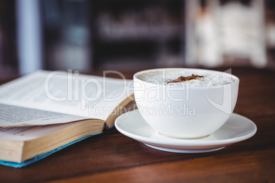 Coffee cup and book on a table
