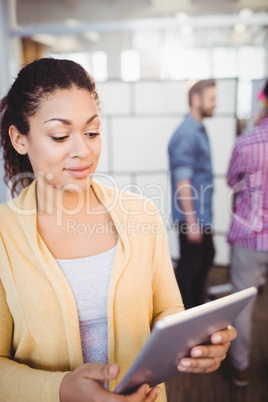 Executive using digital tablet at creative office