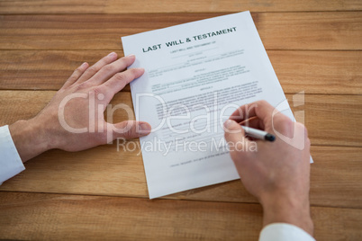 Businessman filling last will and testament form