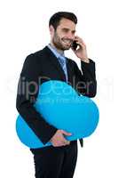 Businessman holding placard talking on mobile phone
