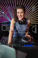 Pretty female DJ playing music