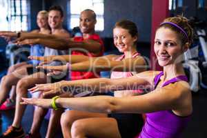Portrait of smiling friends doing stretching exercise