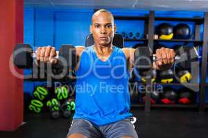 Male athlete exercising in fitness studio