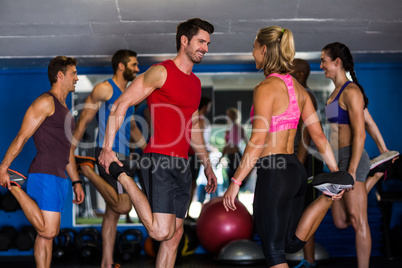 Smiling athletes standing on one leg