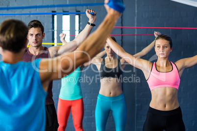 Athletes looking at instructor while exercising